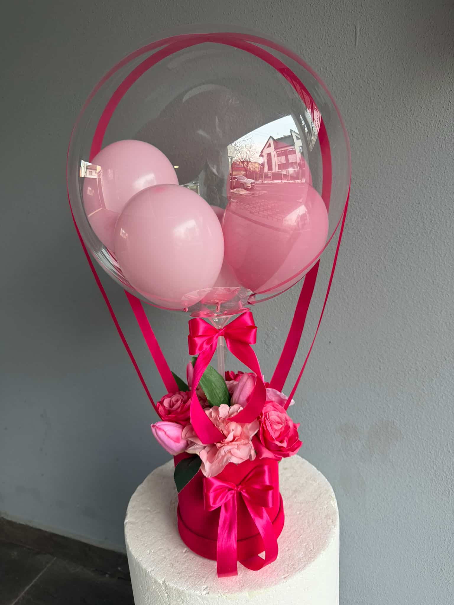 Balon cu flori artificiale și baloane roz Balon transparent cu baloane roz și flori artificiale, decor elegant pentru evenimente speciale.